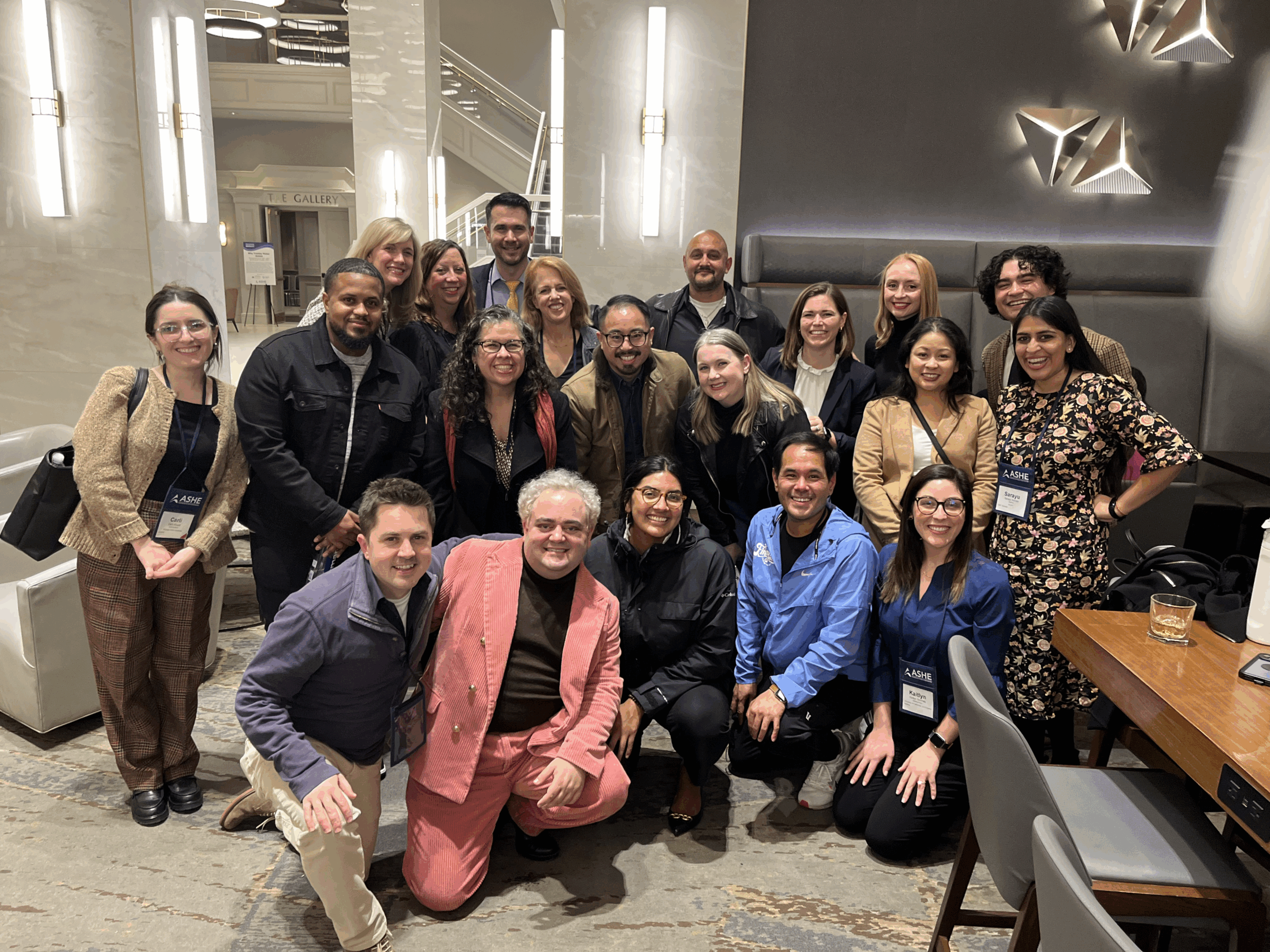 Group of men and women taking a photo at a conference